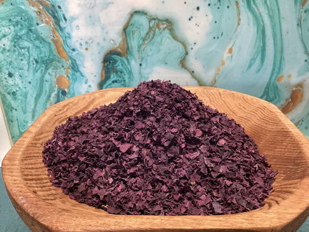 purple dried leaf dulse in a wooden bowl