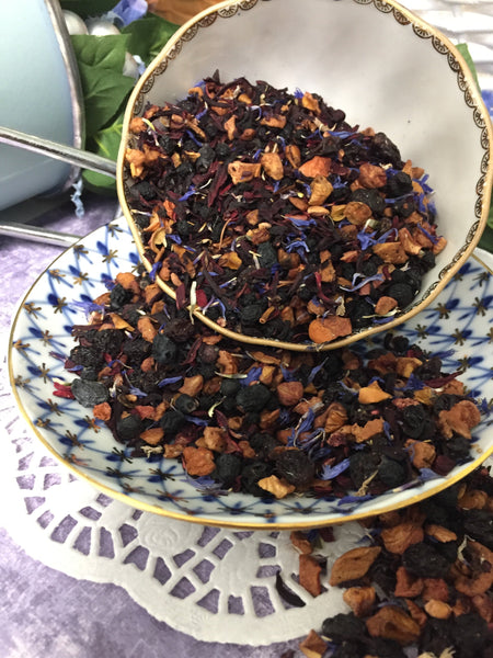 dried tea in porcelain cup that is decorated with blue and gold . The tea has an amazing appearance