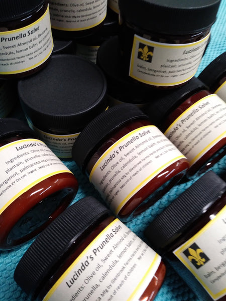 jars of prunella salve in a brown salve jar